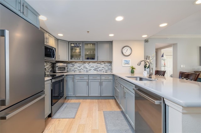 2967 S Atlantic Ave Unit 301, Daytona Beach Shores, FL 32118 - kitchen with appliances with stainless steel finishes, a peninsula, a sink, gray cabinetry, and recessed lighting