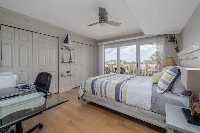 2967 S Atlantic Ave Unit 301, Daytona Beach Shores, FL 32118 - bedroom featuring multiple closets, light wood finished floors, an office area, ceiling fan, and crown molding