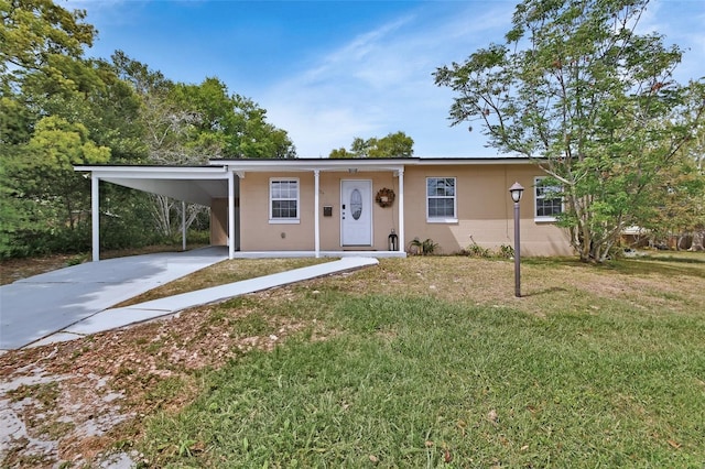 view of front of house featuring a front lawn, a carport, and concrete driveway