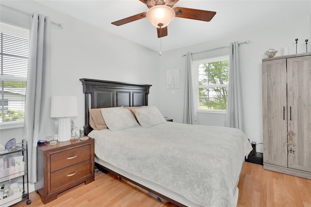 bedroom with a ceiling fan and light wood-type flooring
