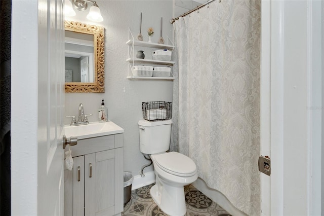 bathroom featuring baseboards, toilet, vanity, and a shower with curtain