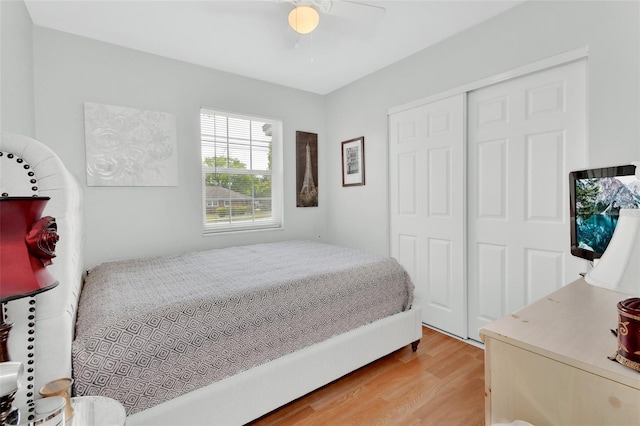 bedroom featuring a closet, wood finished floors, and a ceiling fan