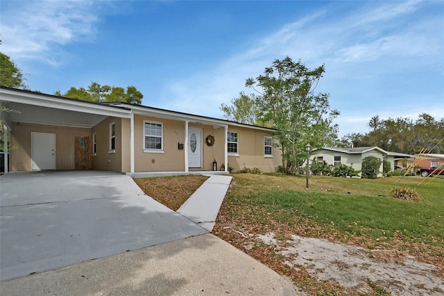 ranch-style house with a front lawn, an attached carport, and driveway