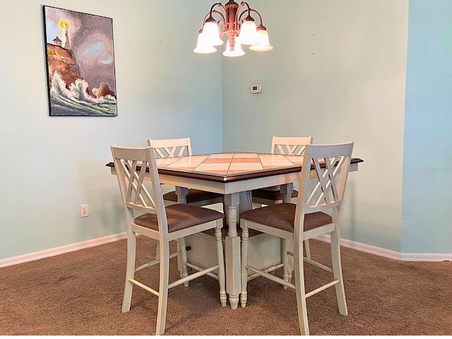 dining space featuring baseboards, carpet flooring, and an inviting chandelier