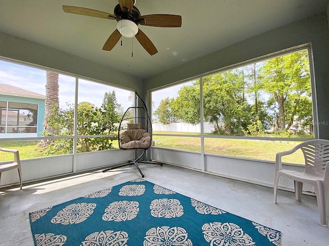 sunroom with plenty of natural light and a ceiling fan