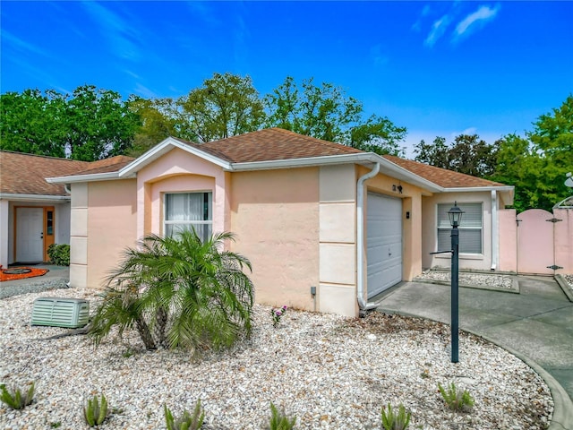 1711 Francisco St, The Villages, FL 32159 - view of front of property with a shingled roof, a gate, stucco siding, and an attached garage