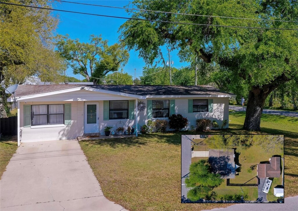 501 Powers Ave, Port Orange, FL 32127 - ranch-style house with concrete driveway and a front lawn
