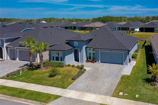 418 Aquamarine Way, Daytona Beach, FL 32124 - ranch-style house with a front yard, stucco siding, an attached garage, a residential view, and decorative driveway