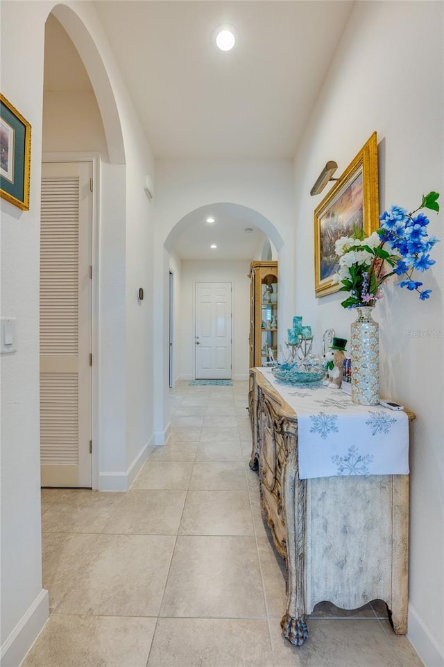 418 Aquamarine Way, Daytona Beach, FL 32124 - hall featuring light tile patterned flooring, baseboards, arched walkways, and recessed lighting