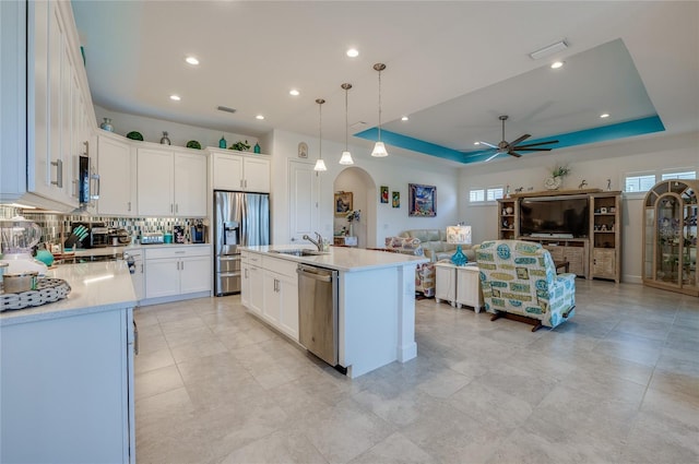 418 Aquamarine Way, Daytona Beach, FL 32124 - kitchen with a ceiling fan, a raised ceiling, arched walkways, appliances with stainless steel finishes, and open floor plan