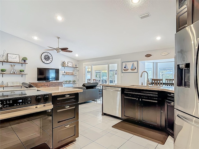 1578 Stone Trl, Deltona, FL 32725 - kitchen with stainless steel appliances, a ceiling fan, open floor plan, lofted ceiling, and a peninsula