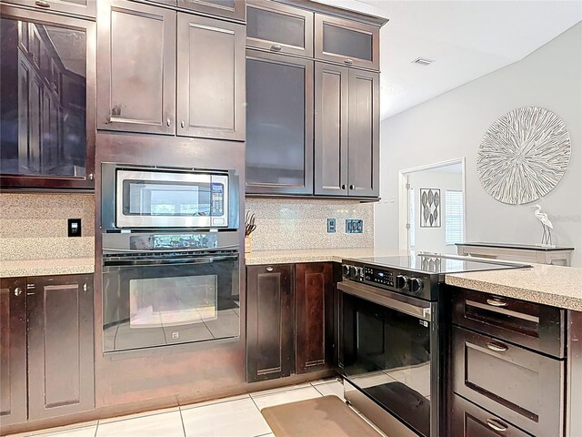 1578 Stone Trl, Deltona, FL 32725 - kitchen with stainless steel appliances, decorative backsplash, glass insert cabinets, and light tile patterned floors