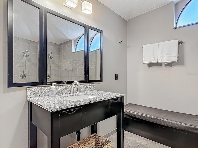 1578 Stone Trl, Deltona, FL 32725 - bathroom featuring a textured ceiling, plenty of natural light, vanity, and tiled shower