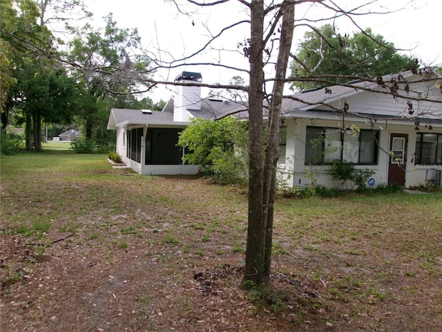 view of yard featuring a sunroom
