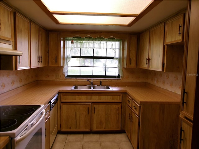 kitchen featuring a sink, dishwasher, white range with electric stovetop, light tile patterned floors, and wallpapered walls