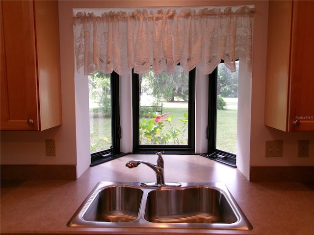 kitchen featuring a wealth of natural light, light countertops, and a sink