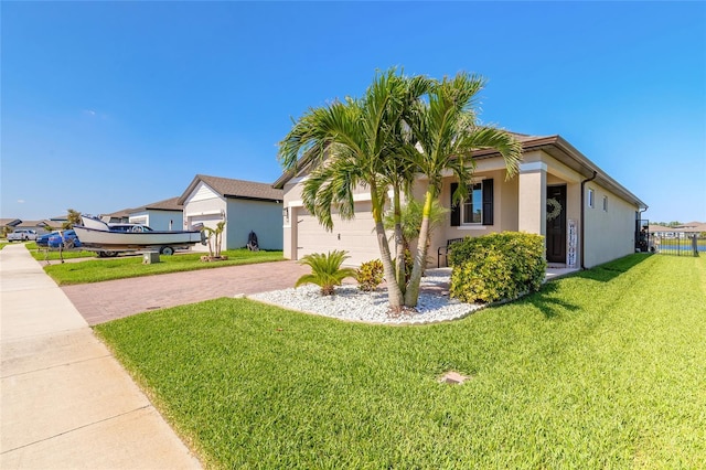 3128 Crab Trap Dr, New Smyrna Beach, FL 32168 - view of front facade with decorative driveway, a front lawn, a garage, and stucco siding
