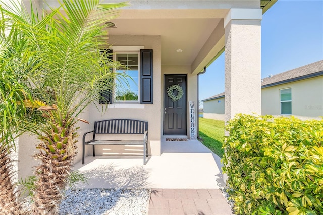 3128 Crab Trap Dr, New Smyrna Beach, FL 32168 - view of exterior entry featuring covered porch and stucco siding