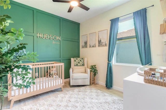 3128 Crab Trap Dr, New Smyrna Beach, FL 32168 - bedroom featuring light wood-style floors, a crib, and baseboards