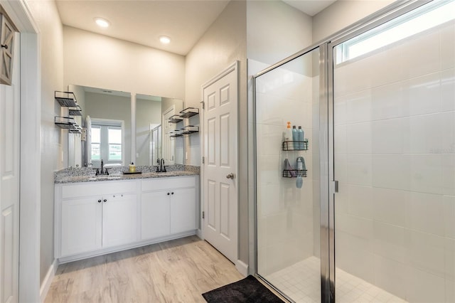 3128 Crab Trap Dr, New Smyrna Beach, FL 32168 - full bath featuring double vanity, a stall shower, wood finished floors, and recessed lighting