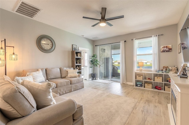 3128 Crab Trap Dr, New Smyrna Beach, FL 32168 - living room featuring a ceiling fan and light wood-style flooring