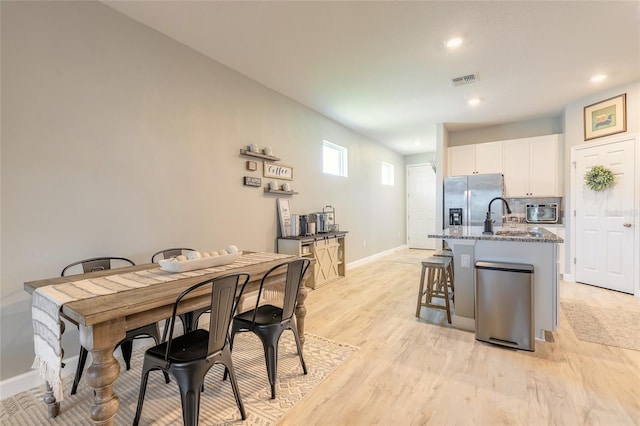 3128 Crab Trap Dr, New Smyrna Beach, FL 32168 - dining space with baseboards, light wood-style flooring, and recessed lighting