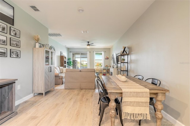 3128 Crab Trap Dr, New Smyrna Beach, FL 32168 - dining space featuring a ceiling fan, light wood finished floors, and baseboards