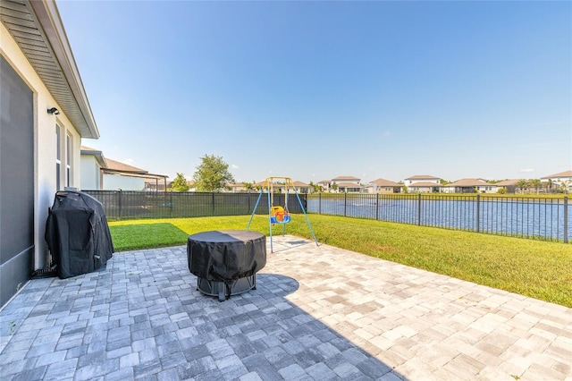 3128 Crab Trap Dr, New Smyrna Beach, FL 32168 - view of patio with a playground, a grill, a residential view, and a water view