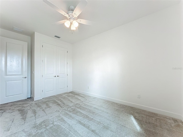unfurnished bedroom with carpet floors, a closet, baseboards, and visible vents