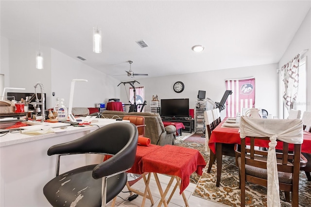 interior space with vaulted ceiling, visible vents, and a ceiling fan