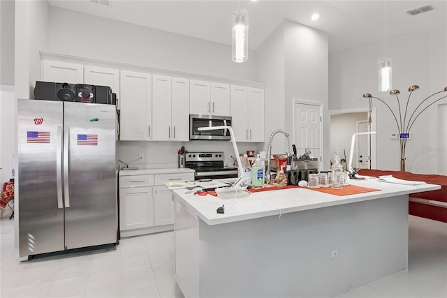 kitchen with visible vents, pendant lighting, white cabinetry, and stainless steel appliances