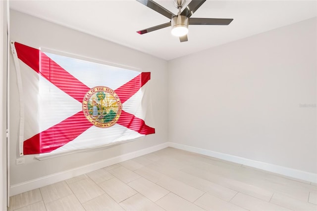 unfurnished room featuring baseboards and a ceiling fan