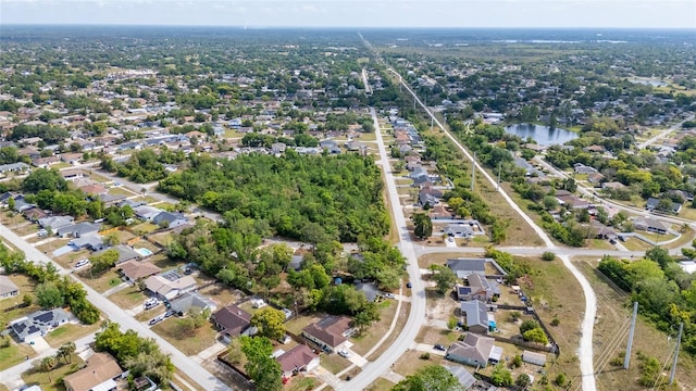 drone / aerial view featuring a residential view and a water view