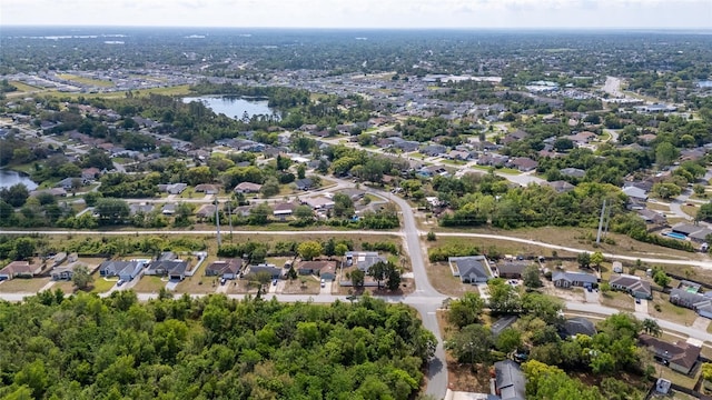 birds eye view of property featuring a residential view and a water view