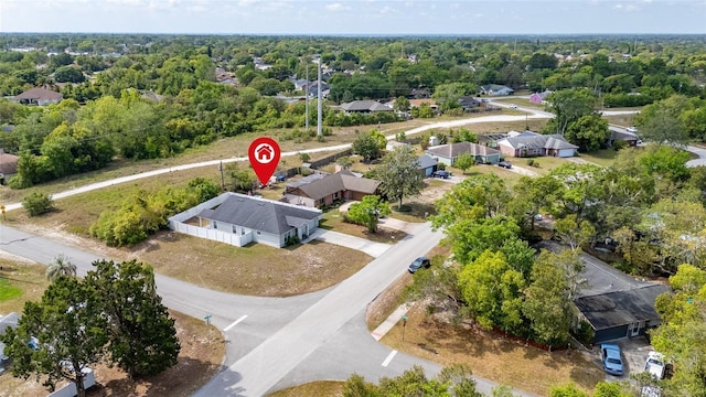 birds eye view of property with a view of trees