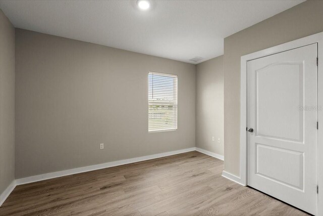 3120 Areca Ave, New Smyrna Beach, FL 32168 - empty room with light wood-style floors, baseboards, and visible vents