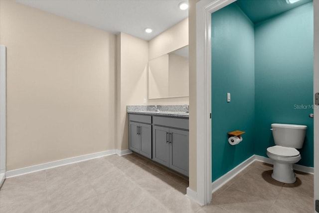3120 Areca Ave, New Smyrna Beach, FL 32168 - bathroom with baseboards, toilet, recessed lighting, vanity, and tile patterned flooring
