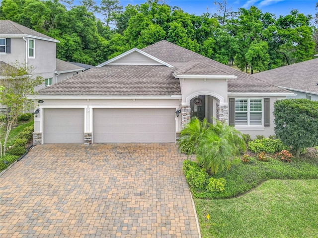 425 Wedgeworth Ln, Deland, FL 32724 - single story home featuring stone siding, a shingled roof, and an attached garage