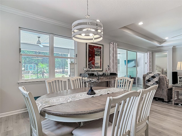 425 Wedgeworth Ln, Deland, FL 32724 - dining area with light wood-style flooring, crown molding, baseboards, recessed lighting, and a notable chandelier