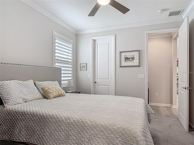 425 Wedgeworth Ln, Deland, FL 32724 - bedroom featuring a textured ceiling, baseboards, visible vents, ceiling fan, and ornamental molding