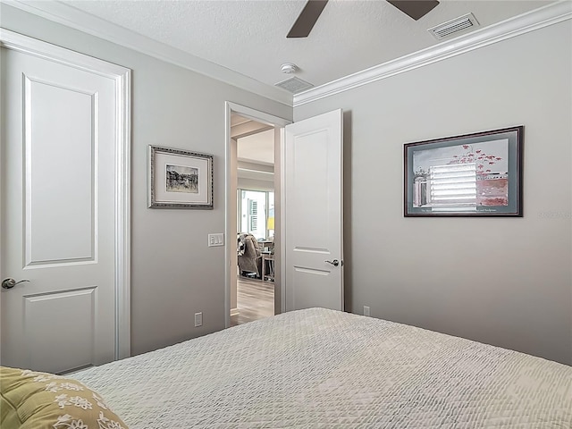 425 Wedgeworth Ln, Deland, FL 32724 - bedroom featuring a ceiling fan, ornamental molding, a textured ceiling, and visible vents