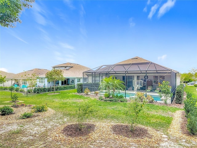 425 Wedgeworth Ln, Deland, FL 32724 - back of house with glass enclosure, a lawn, an outdoor pool, and fence