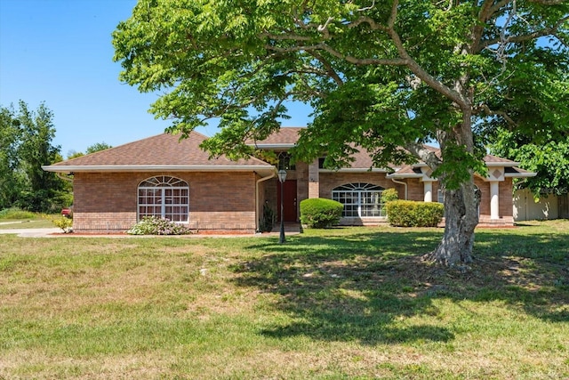 1440 Portola Ave, Deltona, FL 32738 - view of front of house featuring brick siding, a front lawn, and roof with shingles