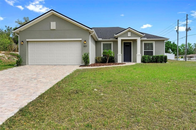 1601 Toledo Ave, Deltona, FL 32725 - view of front of property with a front yard, a shingled roof, an attached garage, stucco siding, and driveway