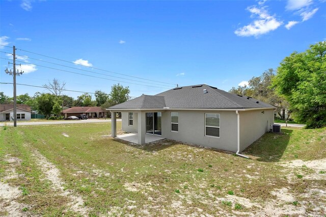 1601 Toledo Ave, Deltona, FL 32725 - rear view of house with a yard, a patio area, stucco siding, and central AC