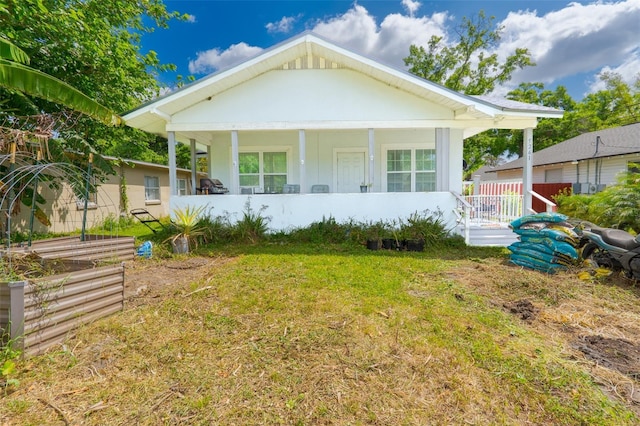 5261 3rd St, Orlando, FL 32810 - bungalow-style home featuring stucco siding, a porch, and a front yard