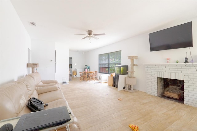 5261 3rd St, Orlando, FL 32810 - living area with a ceiling fan, wood finished floors, a fireplace, and visible vents