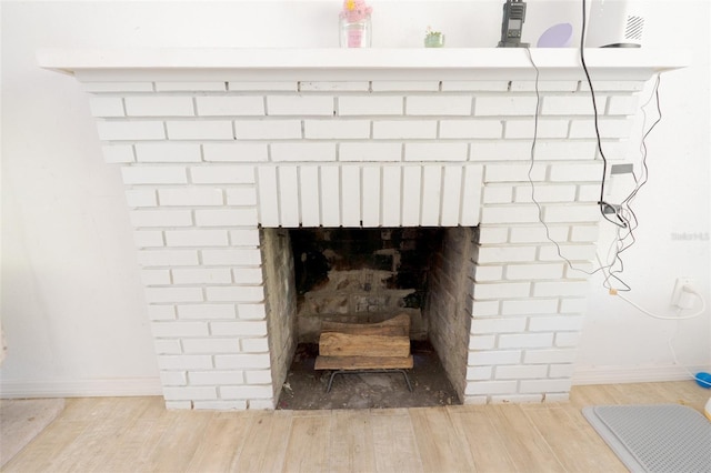 5261 3rd St, Orlando, FL 32810 - details featuring baseboards, wood finished floors, and a brick fireplace