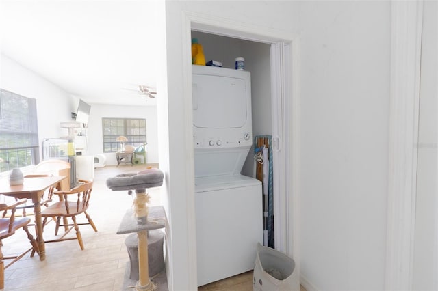 5261 3rd St, Orlando, FL 32810 - washroom with a ceiling fan, stacked washer and dryer, laundry area, and light wood-type flooring