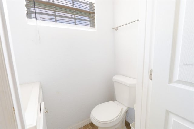 5261 3rd St, Orlando, FL 32810 - bathroom featuring baseboards and toilet